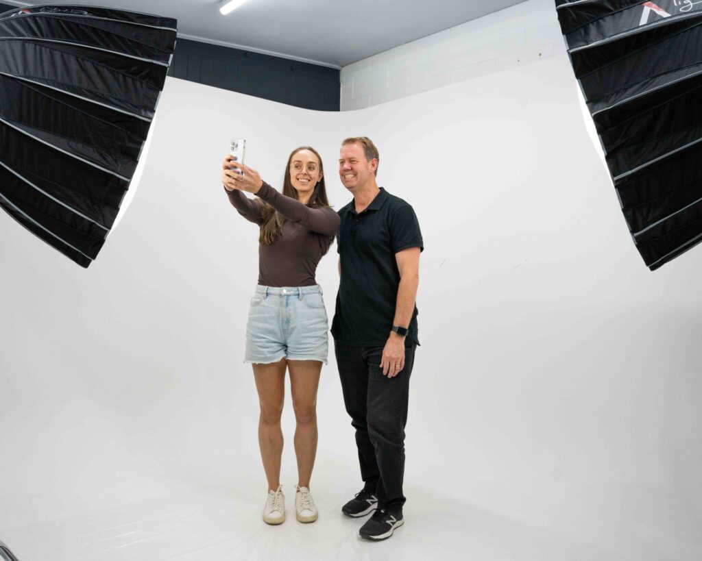 Man and women taking a video and UGC using a iphone for videography